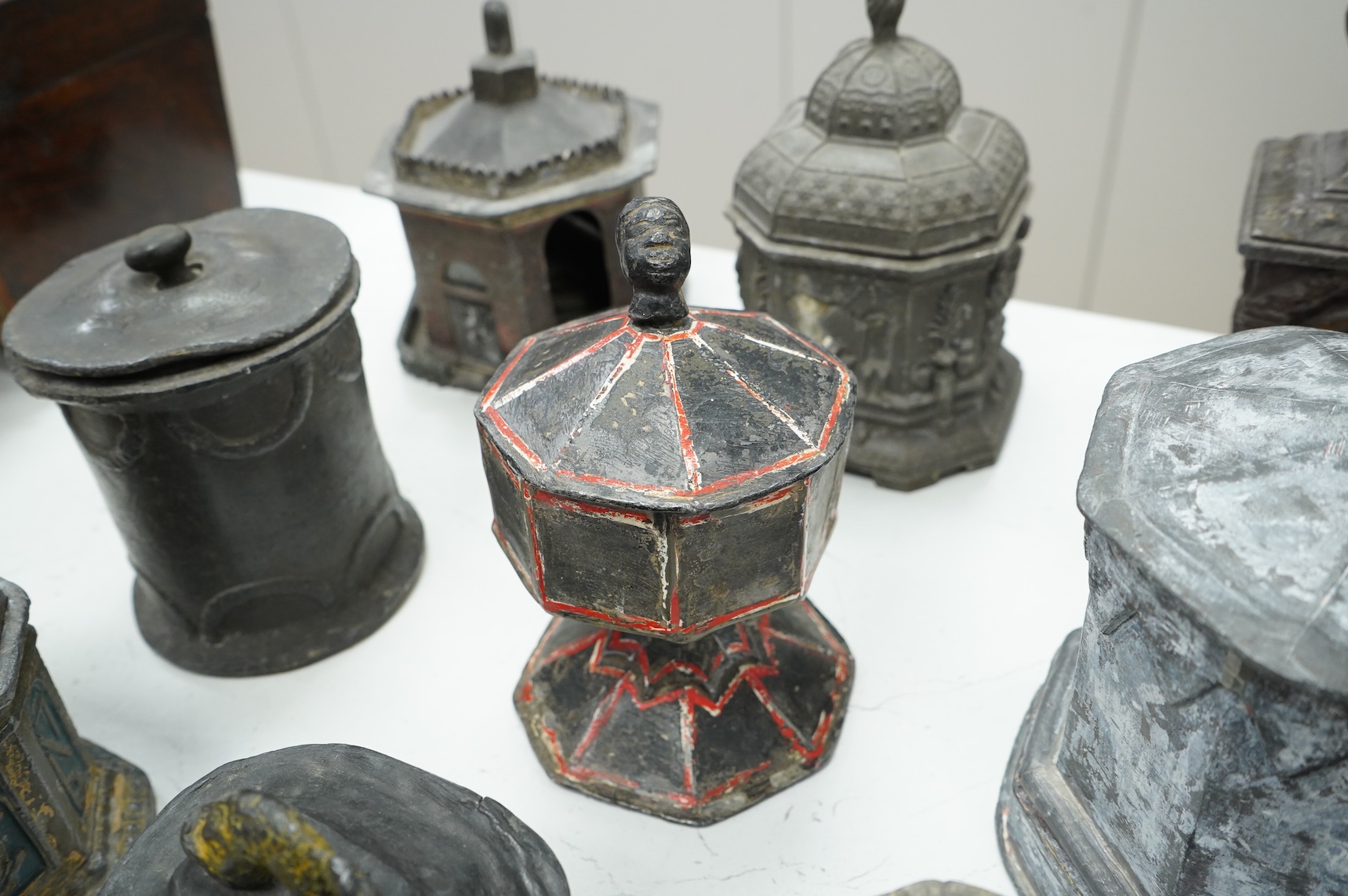 A collection of nine early 19th century lead tobacco boxes and a cover, tallest 20cm